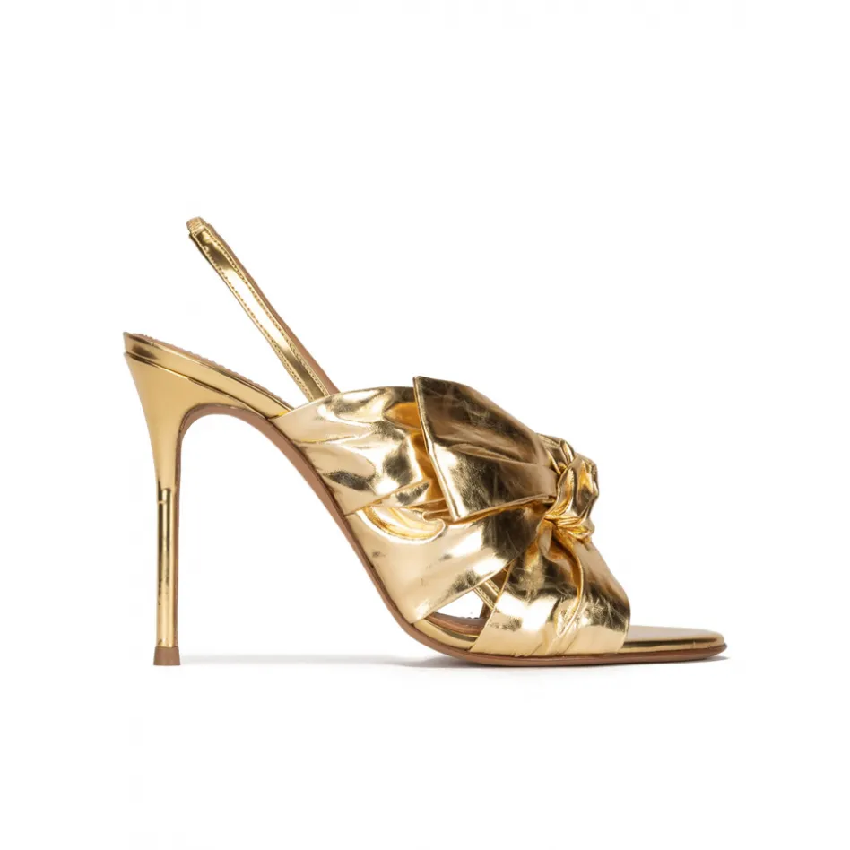 Baroque Bow detailed gold high heel sandals in metallic leather